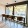 long  countertop with stools in front of large windows with pool view